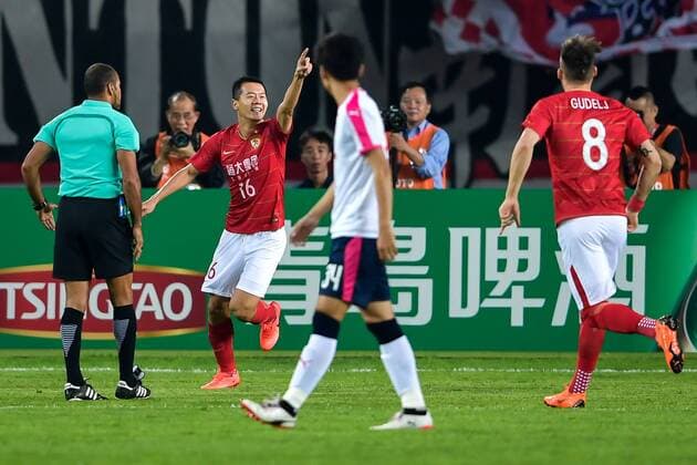 Huang Bowen, second left, of China s Guangzhou Evergrande Taobao FC, celebrates after scoring against Japan s Cerezo Osaka FC in their Group G match during the 2018 AFC Champions League in Guangzhou city, south China s Guangdong province, 17 April 2018. Brazilian striker Alan Carvalho scored twice in the second half to help Guangzhou Evergrande beat the visiting side Cerezo Osaka from Japan 3-1 in a Group G game, final round of the AFC Champions League group stage on Tuesday night. After this game, Guangzhou Evergrande remained unbeaten in this group, earning 12 points and place the first to progress to the knock-out stage of the AFC Champions League, while Buriram United from Thailand managed a 1-0 win over home team Jeju United from South Korea and secured another place in the knock-out stage. Huang Bowen broke the deadlock for Guangzhou Evergrande early in the fifth minute, as the 30-year-old midfielder received the pass from Li Xuepeng, got away from defenders in the penalty area and scored the opening goal. Guangzhou Evergrande beat Cerezo Osaka 3-1 in AFC Champions League 20180417_87915