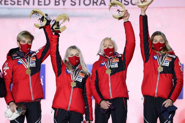 NORDIC SKIING - FIS Nordic World Ski Championships Oberstdorf 2021 OBERSTDORF,GERMANY,27.FEB.21 - NORDIC SKIING, Ski jumping, Skispringen, Ski, nordisch - FIS Nordic World Ski Championships, normal hill, ladies, team event, award ceremony. Image shows the rejoicing of Sophie Sorschag, Chiara Hoelzl, Daniela Iraschko-Stolz and Marita Kramer (AUT). Keywords: medal. GEPAxpictures xChristianxWalgram