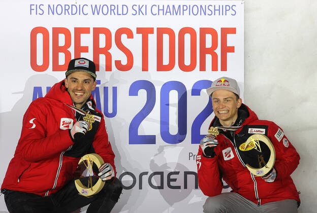 NORDIC SKIING - FIS Nordic World Ski Championships Oberstdorf 2021 OBERSTDORF,GERMANY,06.MAR.21 - NORDIC SKIING, NORDIC COMBINED, Ski jumping, Skispringen, Ski, nordisch - FIS Nordic World Ski Championships, team sprint, large hill, men, award ceremony. Image shows the rejoicing of Lukas Greiderer and Johannes Lamparter (AUT). GEPAxpictures xThomasxBachun