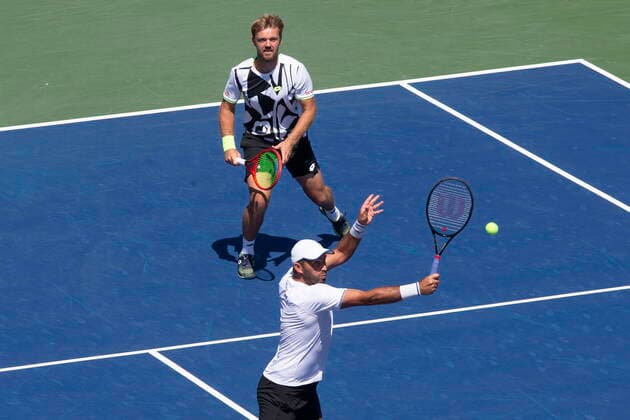 August 14, 2021, Toronto, on, Canada: Kevin Krawietz, top, of Germany, and Horia Tecau, of Romania, return during their 7-6 7-6 loss to Croatia s Nikola Mektic and Mate Pavic in National Bank Open men s tennis action in Toronto, Saturday, Aug. 14, 2021 Kevin Krawietz; Horia Tecau . - ZUMAc35_ 20210814_zaf_c35_012 Copyright: xChrisxYoungx