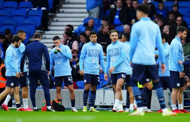 Mandatory Credit: Photo by Javier Garcia Shutterstock (12548169av) Manchester City players warm up wearing t-shirt saying We re with you Guido in support of Belgian Manchester City fan Guido De Pauw, who was attacked after City s win in Bruges last week Brighton & Hove Albion v Manchester City, Premier League, Football, The American Express Stadium, Brighton, UK - 23 Oct 2021 EDITORIAL USE ONLY No use with unauthorised audio, video, data, fixture lists, club league logos or live services. Online in-match use limited to 120 images, no video emulation. No use in betting, games or single club league player publications. Brighton & Hove Albion v Manchester City, Premier League, Football, The American Express Stadium, Brighton, UK - 23 Oct 2021 EDITORIAL USE ONLY No use with unauthorised audio, video, data, fixture lists, club league logos or live services. Online in-match use limited to 120 images, no video emulation. No use in betting, games or single club league player publications. Copyright: xJavierxGarcia Shutterstockx 12548169av