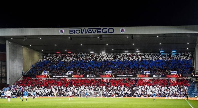 Mandatory Credit: Photo by Stuart Wallace Shutterstock (12617589ci) Rangers fans wave red, white and blue coloured flags in the Broomloan Road Stand. Rangers v Sparta Prague, UEFA Europa League, Group A, Football, Ibrox Stadium, Glasgow, UK - 25 Nov 2021 EDITORIAL USE ONLY No use with unauthorised audio, video, data, fixture lists, club league logos or live services. Online in-match use limited to 120 images, no video emulation. No use in betting, games or single club league player publications. Rangers v Sparta Prague, UEFA Europa League, Group A, Football, Ibrox Stadium, Glasgow, UK - 25 Nov 2021 EDITORIAL USE ONLY No use with unauthorised audio, video, data, fixture lists, club league logos or live services. Online in-match use limited to 120 images, no video emulation. No use in betting, games or single club league player publications. Copyright: xStuartxWallace Shutterstockx 12617589ci