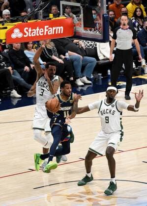 Denver Nuggets guard Monte Morris 11, (C), looks for an open man, while being guarded by Milwaukee Bucks center Bobby Portis 9, (R), and Milwaukee Bucks guard George Hill 3, (L), during the second quarter at the Ball Arena in Denver, CO, USA, 26 November 2021. Denver Nuggets vs. Milwaukee Bucks !ACHTUNG: NUR REDAKTIONELLE NUTZUNG! Copyright: xToddxPiersonx AME952 20211127-166bb308028c3c447c78fc84798c6222fa9f2a47007