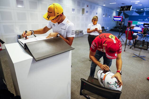 NORRIS Lando (gbr), McLaren MCL35M, LECLERC Charles (mco), Scuderia Ferrari SF21, portrait signing helmet and book for TODT Jean (fra), FIA President during the Formula 1 Etihad Airways Abu Dhabi Grand Prix 2021, 22th round of the 2021 FIA Formula One World Championship, WM, Weltmeisterschaft from December 10 to 12, 2021 on the Yas Marina Circuit, in Yas Island, Abu Dhabi - F1 - ABU DHABI GRAND PRIX 2021 DPPI Panoramic 00121045__V2_8244.JPG