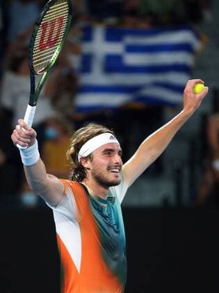 Mandatory Credit: Photo by Ella Ling Shutterstock (12765099ff) Stefanos Tsitsipas celebrates in front of a Greek flag after victory in his fourth round match Australian Open, Day Eight, Tennis, Melbourne Park, Melbourne, Australia - 24 Jan 2022 Australian Open, Day Eight, Tennis, Melbourne Park, Melbourne, Australia - 24 Jan 2022 Copyright: xEllaxLing Shutterstockx 12765099ff