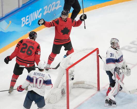 February 12, 2022, Beijing, ON, China: Team Canada forward Robert Knight (9) celebrates with teammate Daniel Winnik (26) after a goal against Team United States goaltender Strauss Mann (31) as Team United States Matty Beniers (10) looks on during second period men™s Ice hockey, Eishockey preliminary action Saturday, February 12, 2022 at the 2022 Winter Olympics in Beijing. Robert Knight, Daniel Winnik, Strauss Mann, Matty Beniers - ZUMAc35_ 20220212_zaf_c35_040 Copyright: xRyanxRemiorzx