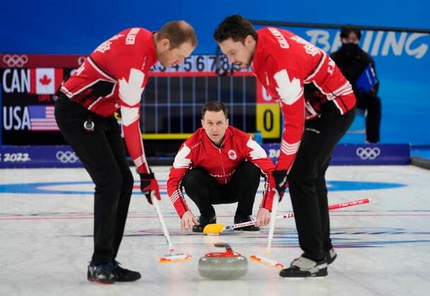 February 18, 2022, Beijing, China: Canada skip Brad Gushue, centre, watches his shot as Geoff Walker, left, and Brett Gallant sweep during men s bronze medal curling action against the United States at the 2022 Winter Olympics in Beijing on Friday, Feb. 18, 2022. Canada News - February 18, 2022 - ZUMAc35_ 20220218_zaf_c35_044 Copyright: xRyanxRemiorzx