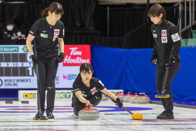 March 20, 2022, Prince George, BC, CANADA: Japan second Minori Suzuki throws a stone flanked by Chiaki Matsumura, left, and Seina Nakajima at CN Centre on Sunday evening during at the Women s World Curling in Prince George, B.C., Sunday, March 20, 2022. Canada News - March 20, 2022 - ZUMAc35_ 20220320_zaf_c35_125 Copyright: xJamesxDoylex