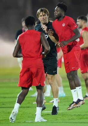 November 25, 2022, DOHA, QATAR: Canada star Alphonso Davies, right, jumps on a member of CanadaöÄÃ s training staff during practice at the World Cup in Doha, Qatar, Friday, Nov. 25, 2022. Canada News - November 25, 2022 - ZUMAc35_ 20221125_zaf_c35_035 Copyright: xNathanxDenettex
