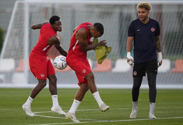 November 26, 2022, DOHA, QATAR: Canada forward Jonathan David, left, throws the ball at teammate Derek Cornelius, centre, as Canada goalkeeper Dayne St. Clair, right, watches during practice at the World Cup in Doha, Qatar on Saturday, November 26, 2022. Canada News - November 26, 2022 - ZUMAc35_ 20221126_zaf_c35_023 Copyright: xNathanxDenettex