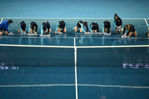 Mandatory Credit: Photo by James Gourley Shutterstock (13729783aq) Ballkids clear the court after rain on the court stops play between Jelena Ostapenko and Elena Rybakina in their Quarter Final Match Australian Open, Day Nine, Tennis, Melbourne Park, Melbourne, Australia - 24 Jan 2023 Australian Open, Day Nine, Tennis, Melbourne Park, Melbourne, Australia - 24 Jan 2023 Copyright: xJamesxGourley Shutterstockx 13729783aq