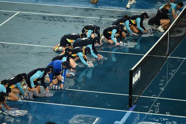 Mandatory Credit: Photo by James Gourley Shutterstock (13729783ao) Ballkids clear the court after rain on the court stops play between Jelena Ostapenko and Elena Rybakina in their Quarter Final Match Australian Open, Day Nine, Tennis, Melbourne Park, Melbourne, Australia - 24 Jan 2023 Australian Open, Day Nine, Tennis, Melbourne Park, Melbourne, Australia - 24 Jan 2023 Copyright: xJamesxGourley Shutterstockx 13729783ao