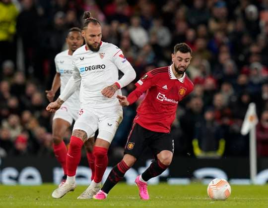 Manchester, England, 13th April 2023. Nemanja Gudelj of Sevilla and Bruno Fernandes of Manchester United, ManU during the UEFA Europa League match at Old Trafford, Manchester. Picture credit should read: Andrew Yates Sportimage EDITORIAL USE ONLY. No use with unauthorised audio, video, data, fixture lists, club league logos or live services. Online in-match use limited to 120 images, no video emulation. No use in betting, games or single club league player publications. SPI-2367-0055