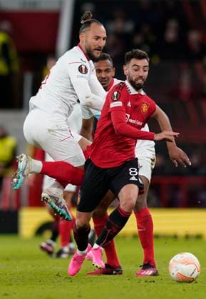 Manchester, England, 13th April 2023. Nemanja Gudelj of Sevilla and Bruno Fernandes of Manchester United, ManU during the UEFA Europa League match at Old Trafford, Manchester. Picture credit should read: Andrew Yates Sportimage EDITORIAL USE ONLY. No use with unauthorised audio, video, data, fixture lists, club league logos or live services. Online in-match use limited to 120 images, no video emulation. No use in betting, games or single club league player publications. SPI-2367-0057
