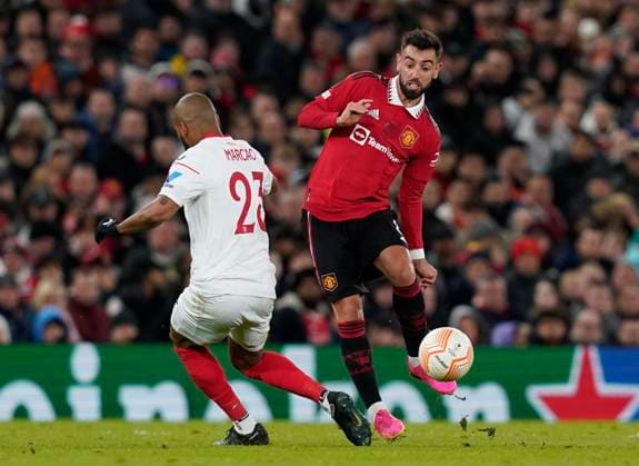 Manchester, England, 13th April 2023. Bruno Fernandes of Manchester United, ManU twist past Marcao of Sevilla during the UEFA Europa League match at Old Trafford, Manchester. Picture credit should read: Andrew Yates Sportimage EDITORIAL USE ONLY. No use with unauthorised audio, video, data, fixture lists, club league logos or live services. Online in-match use limited to 120 images, no video emulation. No use in betting, games or single club league player publications. SPI-2367-0060