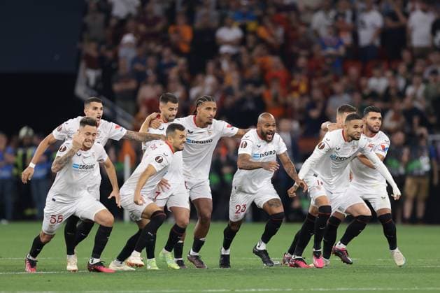 Budapest, Hungary, 31st May 2023. Lucas Ocampos, Erik Lamela, Joan Jordan, Suso, Loic Bade, Marcao, Youssef En-Nesyri, Ivan Rakitic and Karim Rekik of Sevilla celebrate as team mate Gonzalo Montiel scores the winning penalty in the shoot out of the UEFA Europa League match at Puskas Arena, Budapest. Picture credit should read: Jonathan Moscrop Sportimage EDITORIAL USE ONLY. No use with unauthorised audio, video, data, fixture lists, club league logos or live services. Online in-match use limited to 120 images, no video emulation. No use in betting, games or single club league player publications. SPI-2476-0065