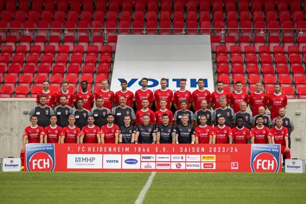 Row 1 Standing on a beer bench From left to right Benedikt Gimber, Tim Siersleben, Omar Traore, Lennard Maloney, Eren Dinkci, Tim Kleindienst, Patrick Mainka, Jan Schöppner, Marvin Pieringer, Denis Thomalla, Thomas Keller, Adrian Beck, Christian Kühlwetter Row 2 Standing on the lawn From left to right Marc Weiss Physiotherapist , Roland Bosch Physiotherapist , Said Lakhal Athletic Trainer , Dieter Jarosch Co Trainer , Frank Schmidt Head Coach , Melvin Ramusovic, Luka Janes, Bernd Weng Goalkeeper Coach , Alexander Raaf Team Manager , Andreas Heintzen Team Doctor , Udo Tiefenbacher Team Doctor , Bernhard Raab Co Trainer , Manuel Henck Zeugwart Row 3 Sitting on the bench From left to right Nikola Dovedan, Tim Köther, Florian Pick, Norman Theuerkauf, Stefan Schimmer, Frank Feller, Vitus Eicher, Kevin Müller, Paul Tschernuth, Jonas Föhrenbach, Marnon Busch, Seedy Jarju, Kevin Sessa, Jan Niklas Beste, GER, FC Heidenheim 1846, Football, 1 Bundesliga, Team photo, Season 2023 2024, 23 07 2023, DFB DFL regulations prohibit any use of photographs as image sequences and or quasi video , GER, FC Heidenheim 1846, Football, 1 Bundesliga, Team photo, Season 2023 2024, 23 07 2023 Heidenheim Copyright: xEibner-Pressefoto SaschaxWaltherx EP_EER