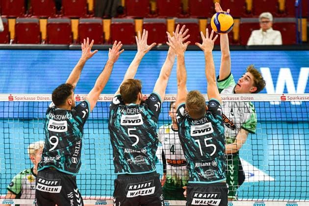 Anton Jung FT Freiburg, 8 right, during a smash against the Düren block by Marcin Ernastowicz Powervolleys Düren, 9 , Luuc von der Ent Powervolleys Düren, 5 and Leo Meyer Powervolleys Düren, 15 , Action, Action, Game scene, 14 11 2023, Düren Germany , Volleyball, 1 Bundesliga, SWD Powervolleys Düren FT 1844 Freiburg xmhx
