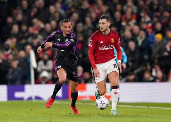 Manchester, England, 12th December 2023. Leroy Sanà of Bayern Munich chases down Diogo Dalot of Manchester United, ManU during the UEFA Champions League match at Old Trafford, Manchester. Picture credit should read: Andrew Yates Sportimage EDITORIAL USE ONLY. No use with unauthorised audio, video, data, fixture lists, club league logos or live services. Online in-match use limited to 120 images, no video emulation. No use in betting, games or single club league player publications. SPI-2800-0021