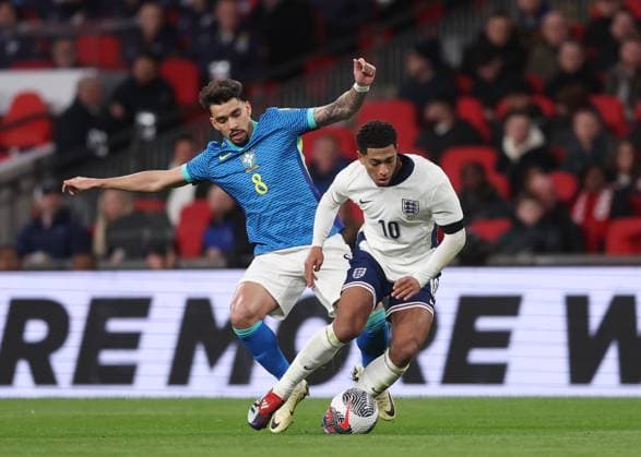 London, England, 23rd March 2024. Lucas Paqueta of Brazil tackles Jude Bellingham of England during the International Friendly, Länderspiel, Nationalmannschaft match at Wembley Stadium, London. Picture credit should read: David Klein Sportimage EDITORIAL USE ONLY. No use with unauthorised audio, video, data, fixture lists, club league logos or live services. Online in-match use limited to 120 images, no video emulation. No use in betting, games or single club league player publications. SPI-3030-0044