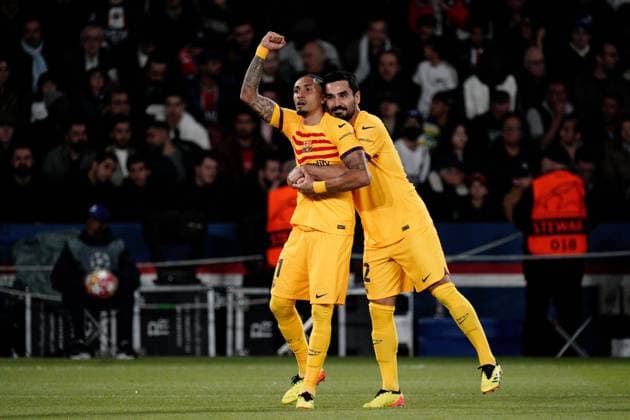 Raphinha of Barcelona is congratulated by Ilkay Gundogan of Barcelona after he puts his side 1-0 ahead Paris Saint-Germain v Barcelona, UEFA Champions League, Quarter Final, First Leg, Football, Parc des Princes, Paris, France - 10 Apr 2024 EDITORIAL USE ONLY No use with unauthorised audio, video, data, fixture lists, club league logos or live services. Online in-match use limited to 120 images, no video emulation. No use in betting, games or single club league player publications. Copyright: xDavexWinter Shutterstockx 14424874aq
