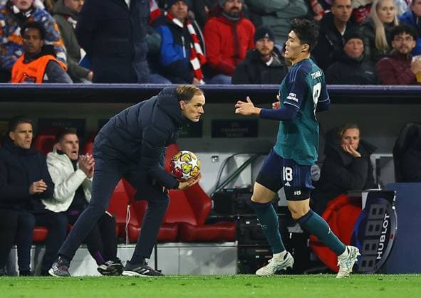 Thomas Tuchel manager of Bayern Munich gathers the ball ahead of Takehiro Tomiyasu of Arsenal Bayern Munich v Arsenal, UEFA Champions League, Quarter Final, Second Leg, Football, Allianz Arena, Munich, Germany - 17 Apr 2024 EDITORIAL USE ONLY No use with unauthorised audio, video, data, fixture lists, club league logos or live services. Online in-match use limited to 120 images, no video emulation. No use in betting, games or single club league player publications. Copyright: xMichaelxZemanek Shutterstockx 14434936i