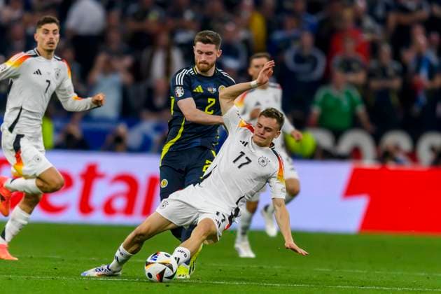 GER, UEFA Euro 2024, Group A, Germany GER vs Scotland SCO 14 06 2024, Allianz Arena, Munich, GER, UEFA Euro 2024, Group A, Germany GER vs Scotland SCO , in the picture Tony Ralston Scottland 2 in a duel against Florian Wirtz Germany 17 nordphotoxGmbHx xStraubmeier nph00004