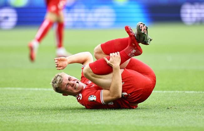 Rasmus Hojlund of Denmark holds his leg after a challenge where his boot fell off his foot Slovenia v Denmark, UEFA European Championship, EM, Europameisterschaft 2024, Group C, Football, Stuttgart Arena, Stuttgart, Germany, 16 Jun 2024 EDITORIAL USE ONLY No use with unauthorised audio, video, data, fixture lists, club league logos or live services. Online in-match use limited to 120 images, no video emulation. No use in betting, games or single club league player publications. Copyright: xMichaelxZemanek Shutterstockx 14539399az