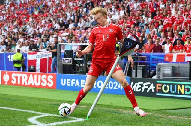 Victor Kristiansen of Denmark keeps the ball in play on the corner flag Slovenia v Denmark, UEFA European Championship, EM, Europameisterschaft 2024, Group C, Football, Stuttgart Arena, Stuttgart, Germany, 16 Jun 2024 EDITORIAL USE ONLY No use with unauthorised audio, video, data, fixture lists, club league logos or live services. Online in-match use limited to 120 images, no video emulation. No use in betting, games or single club league player publications. Copyright: xMichaelxZemanek Shutterstockx 14539399bc