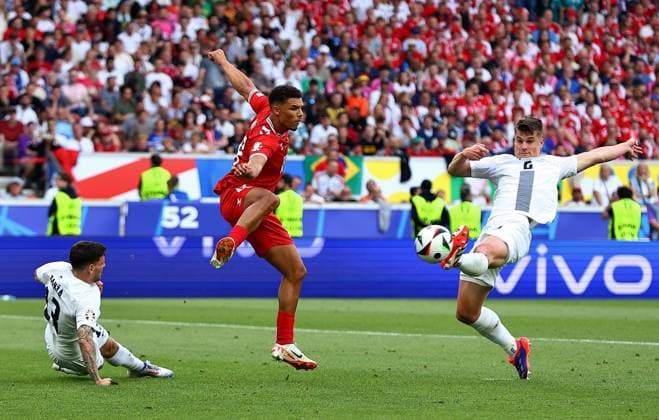 Jaka Bijol of Slovenia attempt on goal is blocked by Alexander Bah of Denmark Slovenia v Denmark, UEFA European Championship, EM, Europameisterschaft 2024, Group C, Football, Stuttgart Arena, Stuttgart, Germany, 16 Jun 2024 EDITORIAL USE ONLY No use with unauthorised audio, video, data, fixture lists, club league logos or live services. Online in-match use limited to 120 images, no video emulation. No use in betting, games or single club league player publications. Copyright: xMichaelxZemanek Shutterstockx 14539399gg