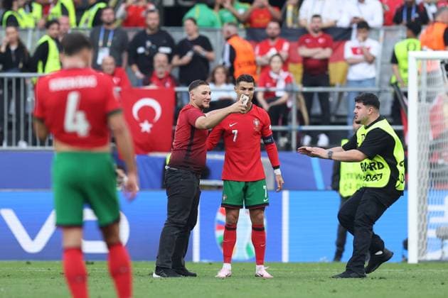 A Turkey fan attempts to take a selfie with Cristiano Ronaldo of Portugal during the match Turkiye v Portugal, UEFA European Championship, EM, Europameisterschaft 2024, Group F, Football, BVB Stadion, Dortmund, Germany, 22 Jun 2024 EDITORIAL USE ONLY No use with unauthorised audio, video, data, fixture lists, club league logos or live services. Online in-match use limited to 120 images, no video emulation. No use in betting, games or single club league player publications. Copyright: xPaulxCurrie Shutterstockx 14548034ey