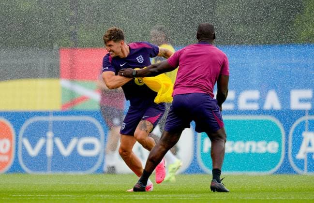 John Stones of England trying to avoid sprinkler England Training, UEFA European Championship, EM, Europameisterschaft 2024, Football, Spa & Golf Resort Weimarer Land, Blankenhain, Germany, 27 Jun 2024 EDITORIAL USE ONLY No use with unauthorised audio, video, data, fixture lists, club league logos or live services. Online in-match use limited to 120 images, no video emulation. No use in betting, games or single club league player publications. Copyright: xDavexShopland Shutterstockx 14559245dn