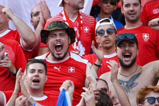Swiss fan block, fans dressed in red, Berlin, UEFA EURO 2024, cheering crowd, enthusiastic supporters, security service, summer, festive atmosphere, fans in red, soccer enthusiasm, spectator stand, sporting event, national team, stadium, passion, cheering fans, emotions, team support, soccer shirts , football, UEFA , European Championship, round of 16 2024, Switzerland vs Italy, 29 06 2024, Olympiastadion Berlin, Berlin, Germany Berlin Olympiastadion Berlin Berlin Germany Copyright: xGrantxHubbsx