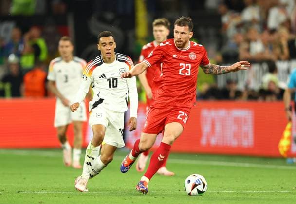 Pierre-Emile Hojbjerg of Denmark and Jamal Musiala of Germany Germany v Denmark, UEFA European Championship, EM, Europameisterschaft 2024, Round of 16, Football, BVB Stadion, Dortmund, Germany - 29 Jun 2024 EDITORIAL USE ONLY No use with unauthorised audio, video, data, fixture lists, club league logos or live services. Online in-match use limited to 120 images, no video emulation. No use in betting, games or single club league player publications. Copyright: xKieranxMcManus Shutterstockx 14562066bx