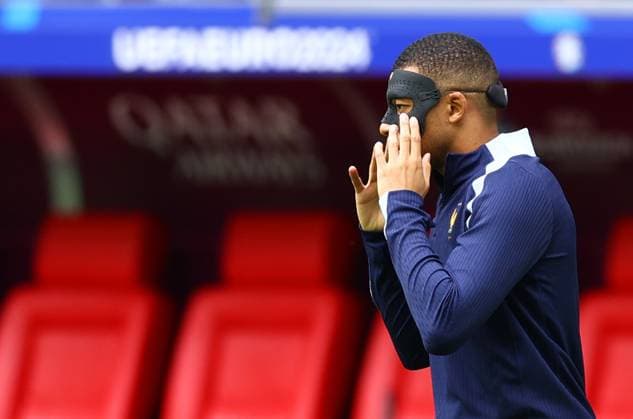 Kylian Mbappe of France puts on his face mask to protect his broken nose during warm up France v Belgium, UEFA European Championship, EM, Europameisterschaft 2024, Round of 16, Football, Dusseldorf Arena, Dusseldorf, Germany - 01 Jul 2024 EDITORIAL USE ONLY No use with unauthorised audio, video, data, fixture lists, club league logos or live services. Online in-match use limited to 120 images, no video emulation. No use in betting, games or single club league player publications. Copyright: xKieranxMcManus Shutterstockx 14566634t