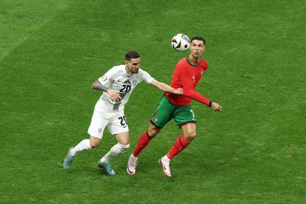 Cristiano Ronaldo of Portugal and Petar Stojanovic of Slovenia Portugal v Slovenia, UEFA European Championship, EM, Europameisterschaft 2024, Round of 16, Football, Frankfurt Arena, Frankfurt, Germany - 01 Jul 2024 EDITORIAL USE ONLY No use with unauthorised audio, video, data, fixture lists, club league logos or live services. Online in-match use limited to 120 images, no video emulation. No use in betting, games or single club league player publications. Copyright: xPaulxCurrie Shutterstockx 14566636af