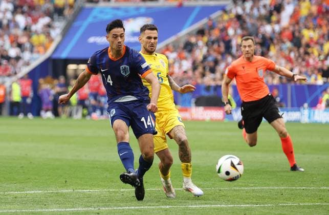Tijjani Reijnders of Netherlands has a shot whilst under pressure from Marius Marin of Romania Romania v Netherlands, UEFA European Championship, EM, Europameisterschaft 2024, Round of 16, Football, Munich Football Arena, Munich, Germany - 02 Jul 2024 EDITORIAL USE ONLY No use with unauthorised audio, video, data, fixture lists, club league logos or live services. Online in-match use limited to 120 images, no video emulation. No use in betting, games or single club league player publications. Copyright: xPaulxCurrie Shutterstockx 14566647bj