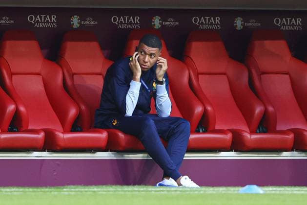 Kylian Mbappà of France sits on their phone in the dugout during the arrivals Spain v France, UEFA European Championship, EM, Europameisterschaft 2024, Semi Final, Football, Munich Football Arena, Munich, Germany - 09 Jul 2024 EDITORIAL USE ONLY No use with unauthorised audio, video, data, fixture lists, club league logos or live services. Online in-match use limited to 120 images, no video emulation. No use in betting, games or single club league player publications. Copyright: xKieranxMcManus Shutterstockx 14576874j