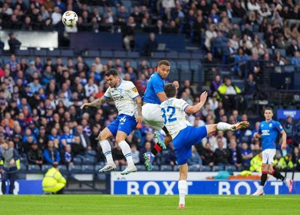 Cyriel Dessers of Rangers heads the ball at the Dynamo Kyiv goal between Vladyslav Dubinchak & Taras Mykhavko of Dynamo Kyiv. Rangers v Dynamo Kyiv, UEFA Champions League, Third Qualifying Round, Second Leg, Football, Hampden Park, Glasgow, UK, 13 Aug 2024 EDITORIAL USE ONLY No use with unauthorised audio, video, data, fixture lists, club league logos or live services. Online in-match use limited to 120 images, no video emulation. No use in betting, games or single club league player publications. Copyright: xStuartxWallace Shutterstockx 14633326l