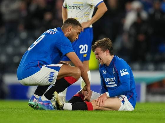 Ridvan Yilmaz of Rangers comforted by Cyriel Dessers of Rangers after injuring his left leg when shooting at goal. Rangers v Dynamo Kyiv, UEFA Champions League, Third Qualifying Round, Second Leg, Football, Hampden Park, Glasgow, UK, 13 Aug 2024 EDITORIAL USE ONLY No use with unauthorised audio, video, data, fixture lists, club league logos or live services. Online in-match use limited to 120 images, no video emulation. No use in betting, games or single club league player publications. Copyright: xStuartxWallace Shutterstockx 14633326as