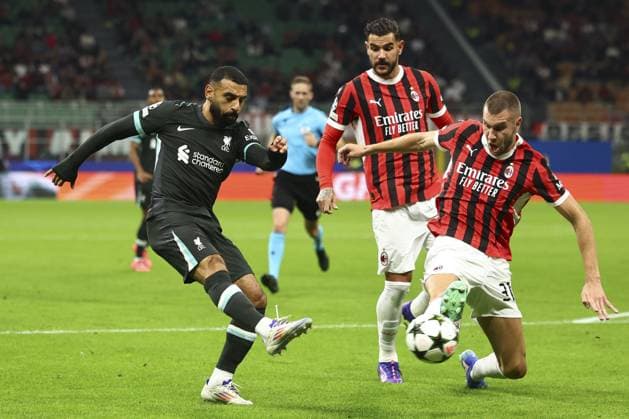 Mohamed Salah of Liverpool with a shot on goal under pressure from Strahinja Pavlovic of Milan AC Milan v Liverpool, UEFA Champions League, Group Stage, Football, San Siro, Milan, Italy, 17 Sep 2024 EDITORIAL USE ONLY No use with unauthorised audio, video, data, fixture lists, club league logos or live services. Online in-match use limited to 120 images, no video emulation. No use in betting, games or single club league player publications. Copyright: xSimonxDael Shutterstockx 14722111q