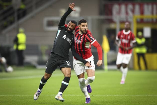 Theo Hernandez of Milan grapples with Mohamed Salah of Liverpool AC Milan v Liverpool, UEFA Champions League, Group Stage, Football, San Siro, Milan, Italy, 17 Sep 2024 EDITORIAL USE ONLY No use with unauthorised audio, video, data, fixture lists, club league logos or live services. Online in-match use limited to 120 images, no video emulation. No use in betting, games or single club league player publications. Copyright: xSimonxDael Shutterstockx 14722111bm