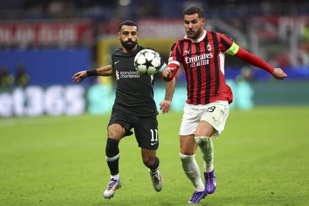 Mohamed Salah of Liverpool and Theo Hernandez of Milan battle for the ball AC Milan v Liverpool, UEFA Champions League, Group Stage, Football, San Siro, Milan, Italy, 17 Sep 2024 EDITORIAL USE ONLY No use with unauthorised audio, video, data, fixture lists, club league logos or live services. Online in-match use limited to 120 images, no video emulation. No use in betting, games or single club league player publications. Copyright: xSimonxDael Shutterstockx 14722111ef