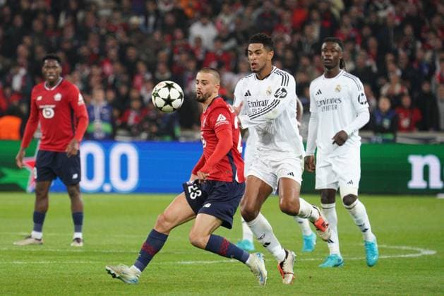 Edon Zhegrova of Lille holds off Jude Bellingham of Real Madrid Lille v Real Madrid, UEFA Champions League, Group Stage, Football, Pierre Mauroy Stadium, Lille, France, 02 Oct 2024 EDITORIAL USE ONLY No use with unauthorised audio, video, data, fixture lists, club league logos or live services. Online in-match use limited to 120 images, no video emulation. No use in betting, games or single club league player publications. Copyright: xDavexWinter Shutterstockx 14750773aq