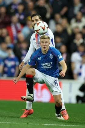 Rayan Cherki of Lyon and Connor Barron of Rangers during the Europa League group phase match at Ibrox Stadium, Glasgow. Rangers v Lyon, UEFA Europa League, Group Stage, Football, Ibrox Stadium, Glasgow, Portugal, 03 Oct 2024 EDITORIAL USE ONLY No use with unauthorised audio, video, data, fixture lists, club league logos or live services. Online in-match use limited to 120 images, no video emulation. No use in betting, games or single club league player publications. Copyright: xO Rourke RangersxFC Shutterstockx 14755166dw