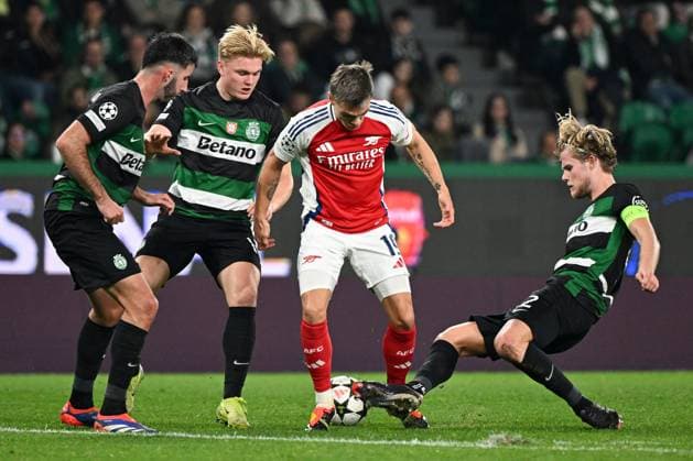 Leandro Trossard of Arsenal is tackled by Morten Hjulmand of Sporting CP Sporting Lisbon v Arsenal, UEFA Champions League, Group Stage, Football, Estadio Jose Alvalade, Lisbon, Portugal - 26 Nov 2024 EDITORIAL USE ONLY No use with unauthorised audio, video, data, fixture lists, club league logos or live services. Online in-match use limited to 120 images, no video emulation. No use in betting, games or single club league player publications. Copyright: xZedxJameson Shutterstockx 14940177fh