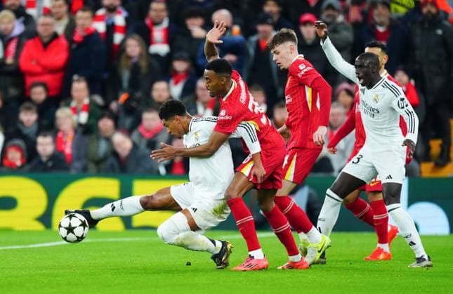 Jude Bellingham of Real Madrid battles with Ryan Gravenberch of Liverpool Liverpool v Real Madrid, UEFA Champions League, Group Stage, Football, Anfield, Liverpool, UK - 27 Nov 2024 EDITORIAL USE ONLY No use with unauthorised audio, video, data, fixture lists, club league logos or live services. Online in-match use limited to 120 images, no video emulation. No use in betting, games or single club league player publications. Copyright: xJavierxGarcia Shutterstockx 14945029ak