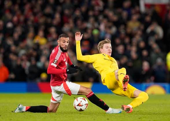 Manchester, England, 28th November 2024. Noussair Mazraoui of Manchester United, ManU tackles Jens Petter Hauge of FK Bodo Glimt during the UEFA Europa League match at Old Trafford, Manchester. Picture credit should read: Andrew Yates Sportimage EDITORIAL USE ONLY. No use with unauthorised audio, video, data, fixture lists, club league logos or live services. Online in-match use limited to 120 images, no video emulation. No use in betting, games or single club league player publications. SPI-3487-0048