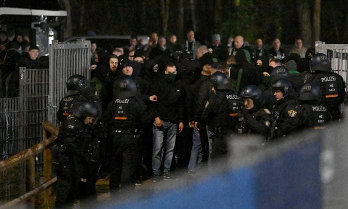 30 11 2024, xfux, Fußball 2 Bundesliga, SV Darmstadt 98 Preussen Münster, emspor, v l Fans or Ultras of Preußen Münster storm from the parking lot for guest fans towards the forest after the game The police are able to push some of the fans back into the parking lot Afterwards there is a confrontation with the police, which can finally push the fans back to the parking lot Obviously because there are not enough police forces and because of the cold, the fans are allowed to drive home without being checked despite the riots Fans, fan, fan block, Mood, scarf, scarves, flag, flags, emotion of SC Preußen Münster Preussen Muenster Violence, riot, riots, rioting, police, fan, fans, Ultras, hooligans, BFE, dog squad, masking, riot, fan riots, riots, rioting, brawl, Security, Sicherheitsdienst DFL DFB REGULATIONS PROHIBIT ANY USE OF PHOTOGRAPHS as IMAGE SEQUENCES and or QUASI VIDEO Licensing of the photographic work to and or by SV Darmstadt 1898 e V and subsidiaries is not permitted No release of or sale to SV Darmstadt 1898 e V Darmstadt