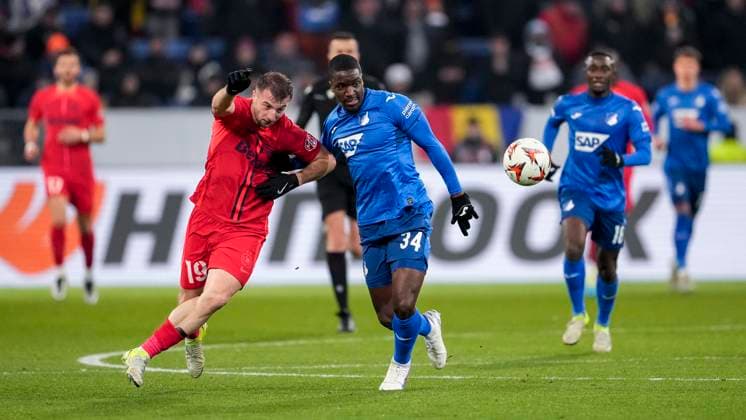 v li Daniel Popa FCSB Bucharest, 19 , Stanley Pierre Nsoki N Soki, Hoffenheim, 34 , duel, duel scene, duel, tackle, tackling, dynamics, action, action, 12 12 2024, Sinsheim Germany , football, UEFA Europa League, group stage, TSG 1899 Hoffenheim FCSB Bucharest, 12 12 2024, Sinsheim Germany , Football, UEFA Europa League, Group stage, TSG 1899 Hoffenheim FCSB Bucharest, DFB DFL REGULATIONS PROHIBIT ANY USE OF PHOTOGRAPHS AS IMAGE SEQUENCES AND OR QUASI VIDEO xozx